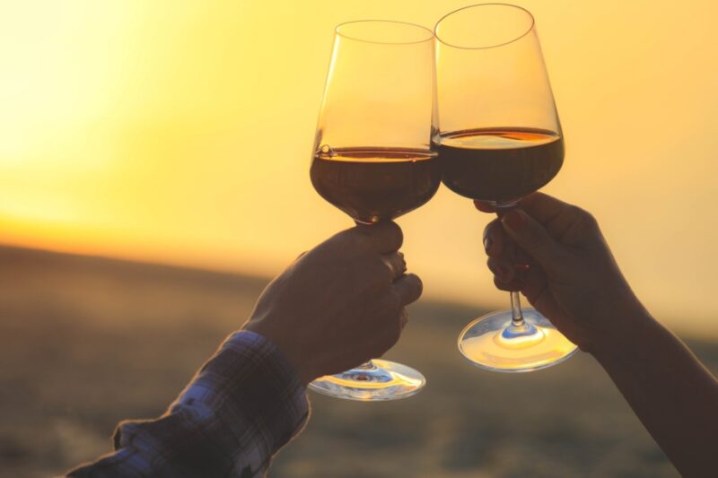 Enjoy toasting wine at sunset.