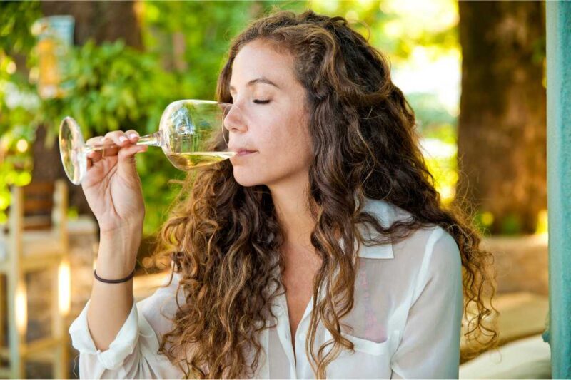 Women sipping wine at a tasting club.