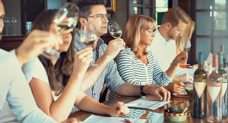 Friends experience wine at wine sampling event